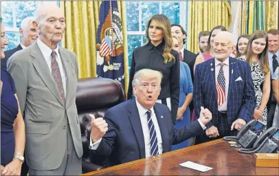  ?? [OLIVIER DOULIERY/ABACA PRESS] ?? President Donald Trump talks about the 50th anniversar­y of the moon landing as Apollo 11 astronauts Buzz Aldrin, right, and Michael Collins, left, listen in the Oval Office. Family members of astronaut Neil Armstrong, who passed away in 2012, also were there.