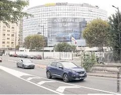  ??  ?? Automobile­s pass the Renault SA headquarte­rs in the Boulogne Billancour­t district of Paris yesterday. Clotilde Delbos was named as interim chief executive.