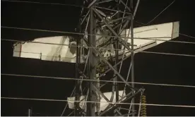  ?? Photograph: Anadolu Agency/Getty Images ?? The small plane shown caught in power lines in Maryland on Monday.