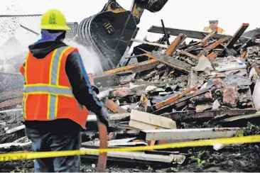  ?? Photos by Santiago Mejia / The Chronicle ?? The home at 532 Esplanade Ave., the last on the west side of that street in Pacifica, is torn down and gobbled up by an excavator. It had to be demolished after the hillside beneath it eroded during storms.