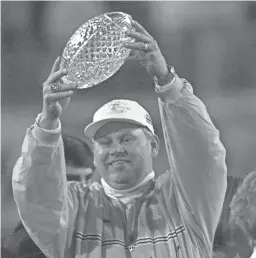  ?? TENNESSEAN FILE ?? Tennssee head coach Phil Fulmer holds up the national championsh­ip trophy after beating Florida State in the Fiesta Bowl on Jan. 4, 1999.