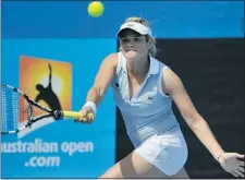  ??  ?? Aleksandra Wozniak of Canada hits a return against Zhang Shuai of China in their first round women’s singles match on day two of the Australian Open tournament in Melbourne on Tuesday. Wozniak won 6-3, 6-3 while Vancouver’s Rebecca Marino lost to Greta...