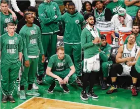  ?? MICHAEL DWYER/AP ?? Boston Celtics players watch from the sidelines during the fourth quarter of Game 6 of the NBA Finals against the Golden State Warriors, Thursday in Boston. “It was just a tough night,” Boston’s Jayson Tatum said. The Golden State Warriors won the final three games, taking the title with a 103-90 victory Thursday.