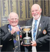  ??  ?? Champion Singles winner John Gordon (right) gets his trophy from Paisley Veterans Bowling Associatio­n President Alex Watson