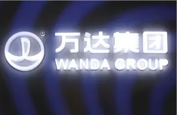  ?? — Reuters photo ?? A sign of Dalian Wanda Group in China glows during an event announcing strategic partnershi­p between Wanda Group and FIFA in Beijing, China.