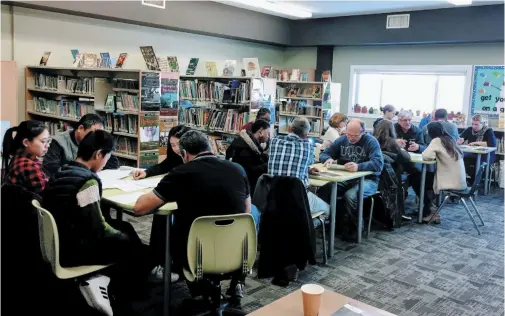  ??  ?? Sunday mornings, students from the world over sharpen their English alongside volunteers at Gateway Church in Winnipeg as part of the church’s English as an Additional Language program.