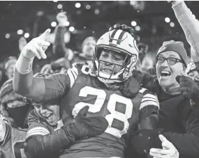  ?? AARON GASH/AP ?? Packers running back AJ Dillon celebrates with fans after rushing for a touchdown against the Seahawks on Sunday in Green Bay, Wis.