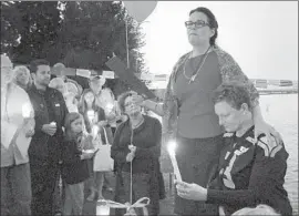  ?? Maria L. LaGanga
Los Angeles Times ?? SYDNEY JO SCHUMACHER’S mother, Diane Schumacher, standing at right, and Bailey SageMeola’s mother, Rochelle Brown, take part in a vigil this month.