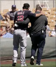  ?? CHARLIE RIEDEL — THE ASSOCIATED PRESS ?? Guardians catcher Luke Maile is helped off the field after getting injured in a spring training game against the Dodgers in Glendale, Ariz.