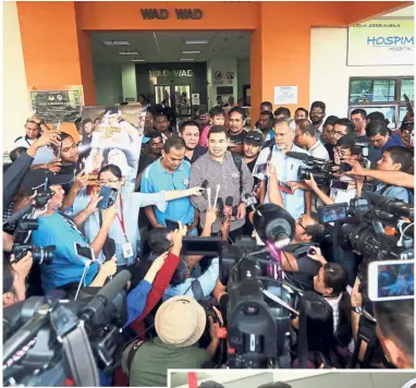  ??  ?? Full-court
press: PKR vice-president Mohd Rafizi Ramli speaking to media outside the Cheras Rehabiliti­on Hospital. (Below)
Dr Wan Azizah is surprised to see a huge crowd at the hospital’s entrance.