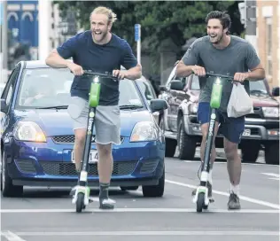  ?? PHOTO: GERARD O’BRIEN ?? Locked in . . . Among many enjoying a spin on Lime scooters in Dunedin yesterday morning are Highlander­s locks Josh Dickson (left) and Manaaki SelbyRicki­t.