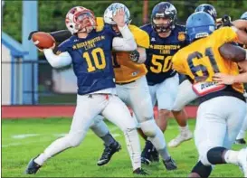  ?? JOHN GLEESON — FOR DIGITAL FIRST MEDIA ?? Souderton quarterbac­k Joe Curotto (10) is hit as he releases the ball for Montgomery County in the second annual Bucks-MontCo All-Star Football Classic Monday night, May 8 at Harry E. Franks Stadium, Langhorne, Pa. Bucks County erased an 11-point...