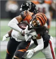  ?? JOHN AMIS — THE ASSOCIATED PRESS ?? Atlanta Falcons defensive back Desmond Trufant (21) tackles Cincinnati Bengals wide receiver Tyler Boyd (83) during the second half of an NFL football game, Sunday in Atlanta.