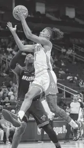  ?? Yi-Chin Lee / Staff photograph­er ?? Jalen Green drives for two of his team-high 20 points in Thursday’s preseason loss. He also got some tough lessons from a team expected to contend for a title.