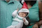  ?? Denis Farrell Associated Press ?? A BABY is dressed for the holiday in Johannesbu­rg, South Africa. Africa’s CDC held an emergency meeting this week over mutations in the coronaviru­s.