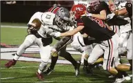  ?? Dave Stewart / Dave Stewart ?? New Canaan’s Griffin Gentner (7) and Walker Blair tackle Naugatuck’s Cayden Martin (13).