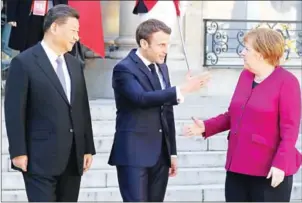 ?? LUDOVIC MARIN/AFP ?? French President Emmanuel Macron (centre) speaks with German Chancellor Angela Merkel (right) and Chinese President Xi Jinping following a meeting at the Elysee Palace in Paris on March 26.