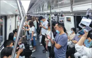  ?? PROVIDED TO CHINA DAILY ?? Subway passengers surf internet on their mobile phones. Leading internet-based companies are now required to end the malpractic­e of blocking each other’s links.