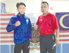  ??  ?? Haikal, seen here with Fabian (right), wins a silver in the National Youth Pre-Sukma Boxing Championsh­ip in Kuala Lumpur over the weekend.