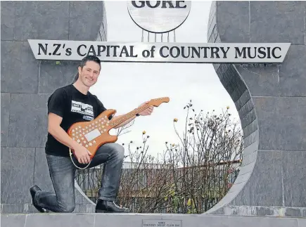  ??  ?? New Zealand Gold Guitar Awards winner Kelvin Cummings with his award at the Tamworth Gardens, in Gore.