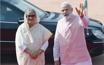  ?? — AFP ?? Prime Minister Narendra Modi (R) welcoming Bangladesh Prime Minister Sheikh Hasina during a ceremonial reception at Presidenti­al house in New Delhi on Saturday.