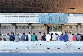  ?? ?? PEOPLE queue outside the Refugee Reception Office in Cape Town. Our problems with bureaucrac­y arise, not from the bureaucrac­y itself, but from the government (elected or otherwise) that creates more programmes and regulation­s for the bureaucrac­y to manage and to be enforced, the writer says. | African News Agency (ANA) archives