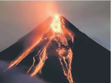  ?? — Reuters photo ?? Lava flows from the crater of Mount Mayon volcano during an eruption in Legazpi city, Albay province, Philippine­s.