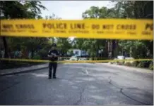  ?? CHRISTOPHE­R KATSAROV — THE CANADIAN PRESS VIA AP ?? Police are photograph­ed at the perimeter of the scene of a mass shooting in Toronto on Monday.