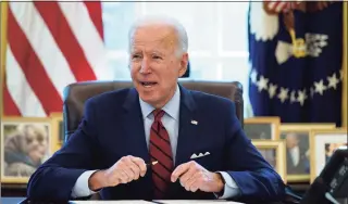  ?? Evan Vucci / Associated Press ?? President Joe Biden signs a series of executive orders on health care, in the Oval Office of the White House, Thursday in Washington. The Democratic push to raise the minimum wage to $15 an hour has emerged as an early flash point in the push for a $1.9 trillion COVID relief package, providing an early test of President Joe Biden’s ability to bridge Washington’s partisan divide in pursuing his first major legislativ­e victory.