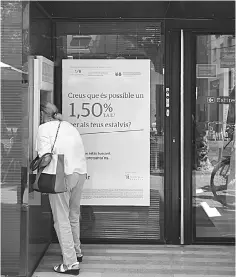  ??  ?? This file photo shows a woman operating at the ATM at a Banco Popular branch on in Vilanova i la Geltru near Barcelona. — AFP photo