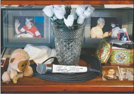  ?? (AP/John Minchillo) ?? A signed microphone by The Who’s Roger Daltrey on display in a memorial cabinet at the Finneytown High School secondary campus in Finneytown, Ohio.