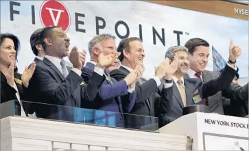  ?? Richard Drew Associated Press ?? FIVE POINT pitched itself to investors partly on the low level of housing in California, relative to jobs and population growth. Above, company CEO Emile Haddad, second from right, rings the NYSE opening bell.