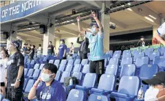  ??  ?? BACK IN BALLPARK: Fans cheer their team at the first profession­al league game that allowed audience since the coronaviru­s outbreak.