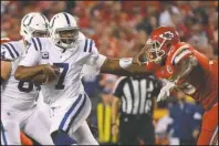  ?? The Associated Press ?? AVOIDING PRESSURE: Indianapol­is Colts quarterbac­k Jacoby Brissett (7) runs away from pressure by Kansas City Chiefs defensive tackle Chris Jones, right, during the first half of Sunday’s game in Kansas City, Mo.
