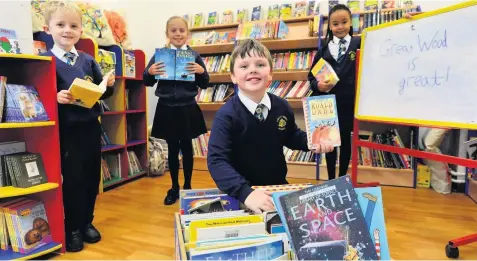  ??  ?? WORDSMITHS: Jack Harris, Molly Cooper, Sydney Brindley and Jessica Beardmore brush up on their reading skills at Great Wood Primary, in Upper Tean.