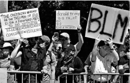  ?? NICHOLAS KAMM/GETTY-AFP ?? Protesters line the street near the Dallas campus of Gateway Church as President Donald Trump arrives Thursday for a roundtable discussion on race and policing efforts.