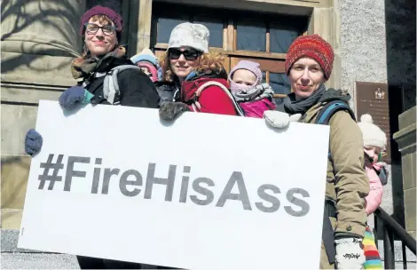  ?? PAUL DALY/THE CANADIAN PRESS ?? Hope Jamieson Baggs, left, and daughter Ruth, Kelly Hickey, centre, and daughter Violet, and Jen Daniels, right, with her child Casey helped organized a rally at police headquarte­rs in St. John’s on Monday following a weekend of outrage after a...