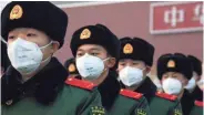 ?? BETSY JOLES/GETTY IMAGES ?? Chinese police wear masks in Beijing. Authoritie­s tightened restrictio­ns on travel and tourism amid the coronaviru­s crisis.
