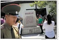  ?? AP/DITA ALANGKARA ?? Chinese tourists take photos Wednesday outside the Museum of the Armistice Agreement in Panmunjom, North Korea.