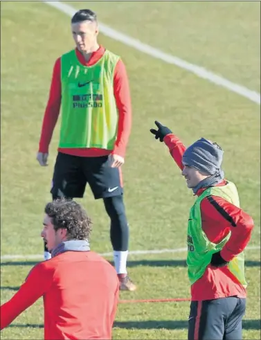 ??  ?? PAREJA. Griezmann señala a Torres durante un ejercicio ayer en el entrenamie­nto del Atlético.