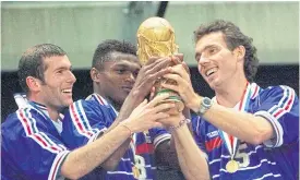  ??  ?? France’s Laurent Blanc, right, and teammates lift the Fifa trophy in 1998.