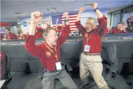  ?? REUTERS ?? LEFT Nasa engineers Kris Bruvold, left, and Sandy Krasner react in the space flight operation facility at Nasa’s Jet Propulsion Laboratory (JPL) as the spaceship InSight lands on the surface of Mars after a six-month journey, at JPL in Pasadena, California on Monday.