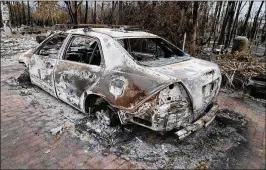  ?? PEDRO PORTAL / MIAMI HERALD ?? This burned car sits at the house owned by Chris Arsenault in Big Pine Key. Arsenault lost his house in the Big Pine Key fire that broke out April 22.