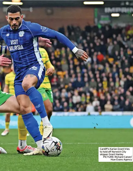  ?? ?? Cardiff’s Karlan Grant tries to hold off Norwich City skipper Grant Hanley PICTURE: Richard Calver/ Huw Evans Agency