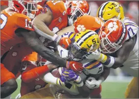  ?? GERALD HERBERT - THE ASSOCIATED PRESS ?? FILE - In this Jan. 13, 2020, file photo, LSU wide receiver Justin Jefferson is tackled by the Clemson defense during the first half of a NCAA College Football Playoff national championsh­ip game in New Orleans.