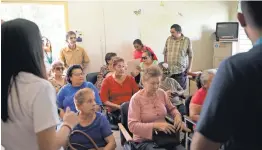  ??  ?? Residents of Jayuya listen to aid workers who came from nearby Ponce, Puerto Rico, to offer help and informatio­n.