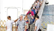  ??  ?? Passengers from cruise ships being quarantine­d at Port of Colombo