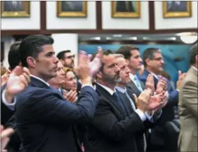  ?? SCOTT KEELER — TAMPA BAY TIMES VIA AP ?? On Wednesday in Tallahasse­e, Fla., Rep. Jose Oliva, R-Miami Lakes, front, and other members of the Florida House applaud Marjory Stoneman Douglas High School parent Andrew Pollack, whose daughter, Meadow Pollack, was killed in a school shooting.