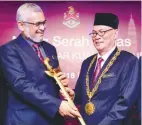  ??  ?? Khalid presenting a ceremonial keris to Nor Hisham during the handing-over of duties event at Menara DBKL yesterday.