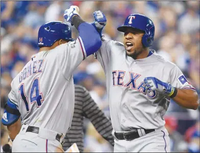  ?? Associated Press ?? Can Rangers contend for title?: In this Oct. 9, 2016, file photo, Texas' Elvis Andrus, right, celebrates his solo home run with teammate Carlos Gomez during the third inning in Game 3 of the American League Division Series in Toronto. Now that the Cubs...